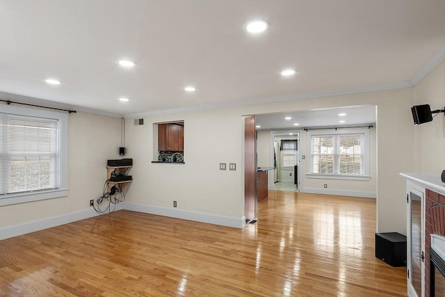 living room featuring ornamental molding and light hardwood / wood-style flooring