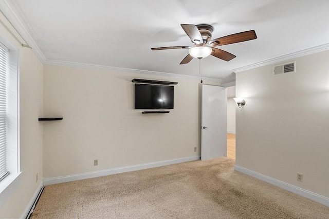 spare room featuring crown molding, ceiling fan, and light carpet