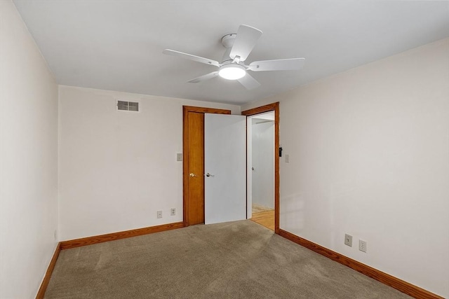 empty room with ceiling fan and light colored carpet