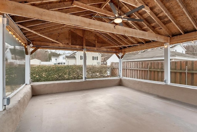 unfurnished sunroom featuring vaulted ceiling