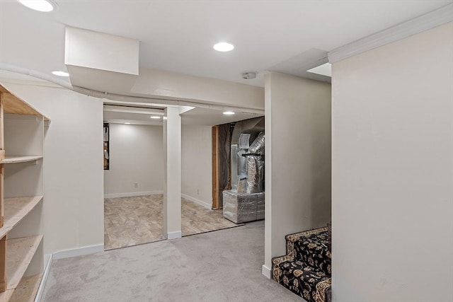 basement with light carpet and ornamental molding