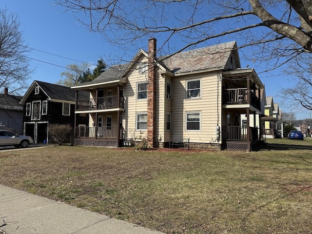 40 Allen St, Greenfield, MA 01301 - view of home's exterior featuring a balcony, a chimney, and a yard