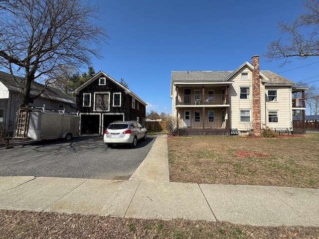 40 Allen St, Greenfield, MA 01301 - view of front facade featuring a balcony, a chimney, and a front yard
