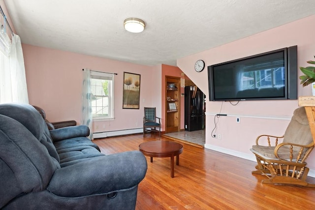 66 Adams St, Revere, MA 02151 - living area with a baseboard radiator and wood finished floors