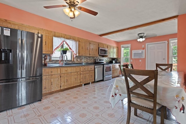 66 Adams St, Revere, MA 02151 - kitchen with stainless steel appliances, dark countertops, tasteful backsplash, a ceiling fan, and brown cabinets