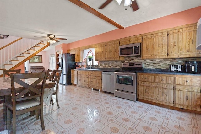 66 Adams St, Revere, MA 02151 - kitchen with appliances with stainless steel finishes, a ceiling fan, dark countertops, tasteful backsplash, and brown cabinets