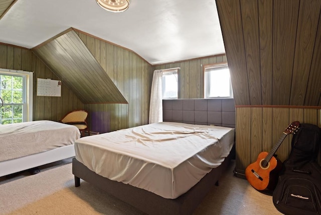 66 Adams St, Revere, MA 02151 - carpeted bedroom featuring multiple windows, vaulted ceiling, and wooden walls