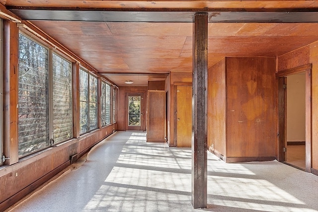 unfurnished sunroom with wood ceiling