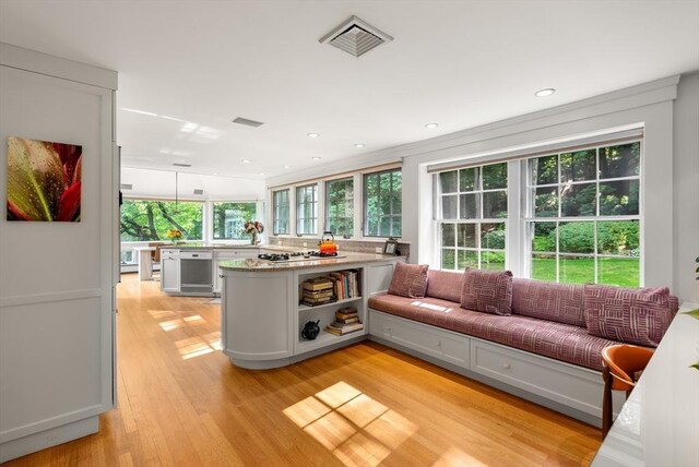 interior space featuring visible vents, dishwasher, light stone counters, light wood-style floors, and open shelves