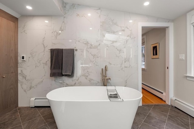 bathroom featuring a baseboard heating unit, a soaking tub, and a baseboard radiator