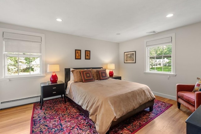 bedroom with baseboards, visible vents, wood finished floors, and recessed lighting