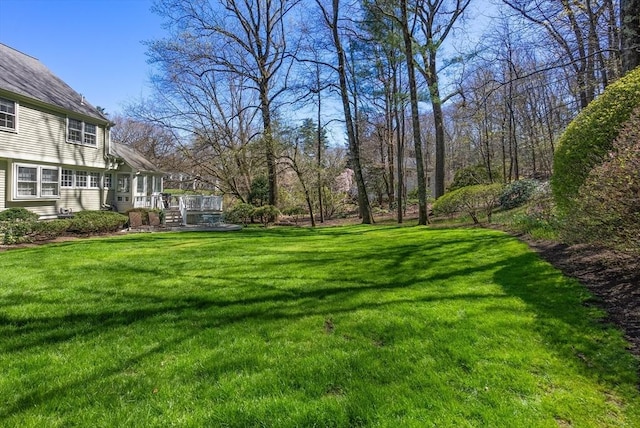 view of yard with a wooden deck