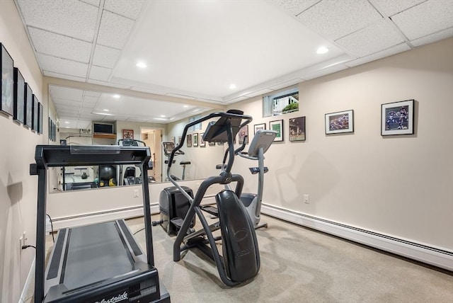 workout room with a baseboard radiator, a paneled ceiling, and recessed lighting