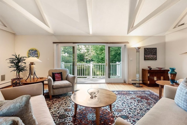 living area featuring vaulted ceiling with beams, a baseboard radiator, and wood finished floors