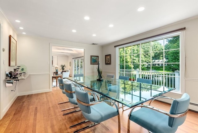 dining area with light wood-style floors, plenty of natural light, crown molding, and recessed lighting