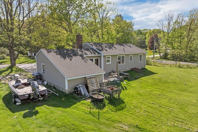 367 Main St, Hampstead, NH 03841 - back of property featuring a yard, a shingled roof, and a chimney