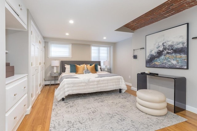 bedroom featuring recessed lighting, baseboards, a baseboard radiator, and light wood finished floors