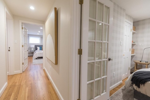 hallway featuring recessed lighting, light wood-style flooring, and baseboards