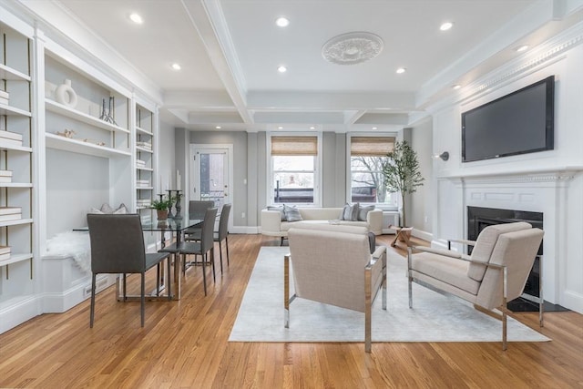 living area featuring crown molding, a fireplace, recessed lighting, baseboards, and light wood-type flooring