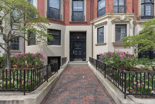 entrance to property featuring brick siding
