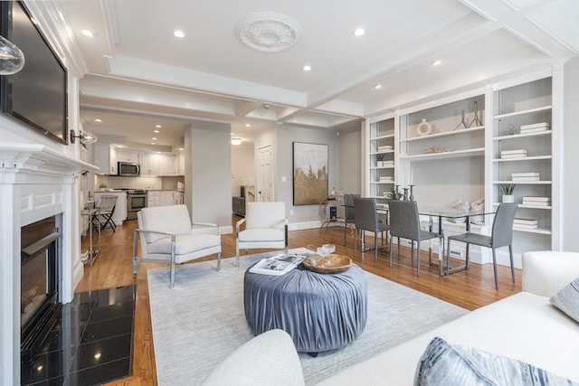 living room featuring a glass covered fireplace, recessed lighting, beam ceiling, and dark wood finished floors