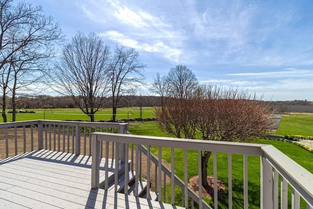 wooden terrace with a lawn