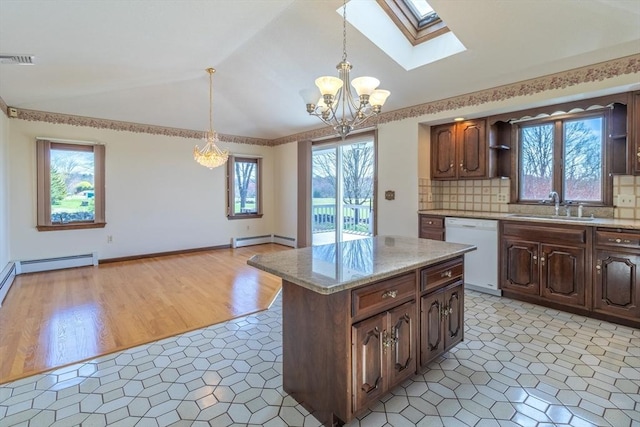kitchen featuring a chandelier, a baseboard heating unit, white dishwasher, a sink, and visible vents