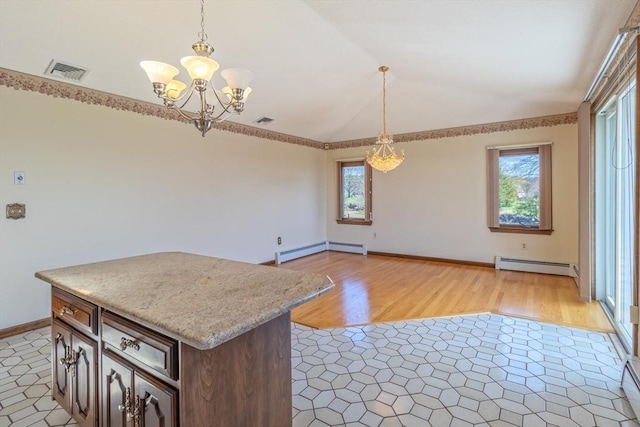 kitchen with vaulted ceiling, a wealth of natural light, a notable chandelier, and a baseboard heating unit