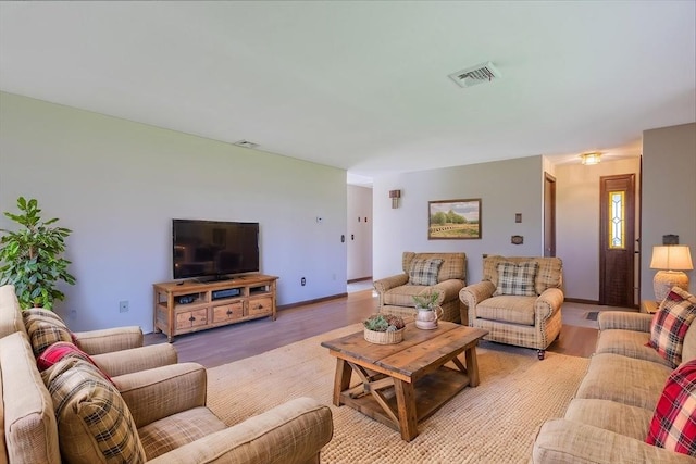 living room featuring visible vents and light wood-type flooring