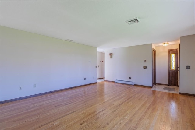 unfurnished living room with a baseboard radiator, visible vents, light wood-type flooring, and baseboards