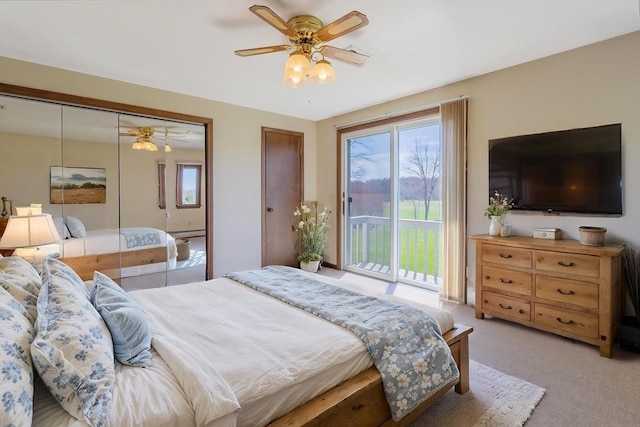 bedroom featuring light colored carpet, ceiling fan, and access to exterior