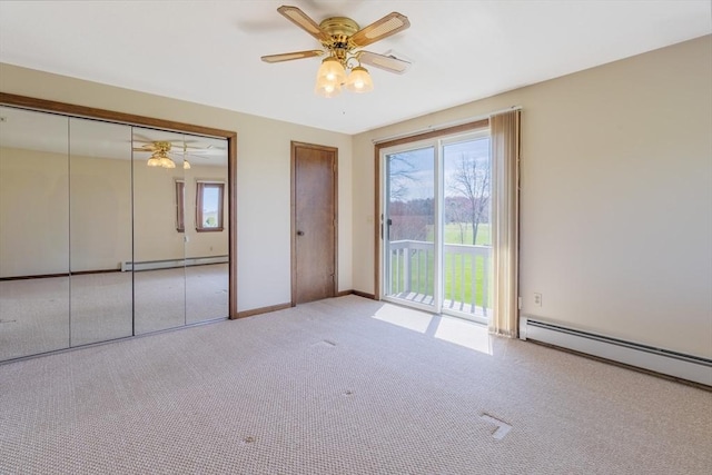 interior space featuring baseboards, access to exterior, a baseboard heating unit, and carpet flooring
