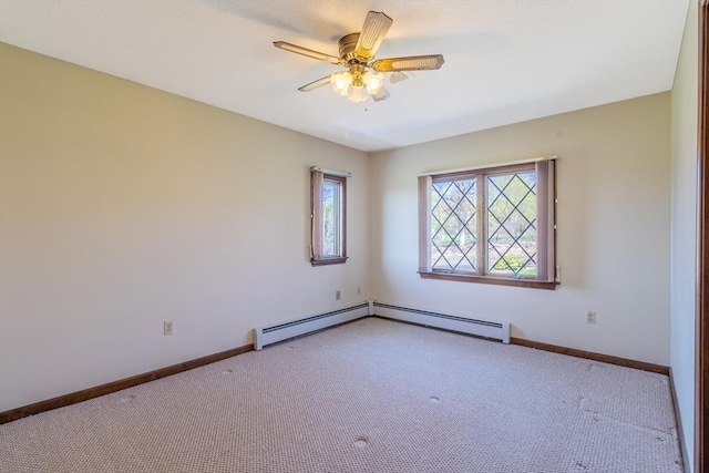 carpeted empty room featuring baseboards and ceiling fan