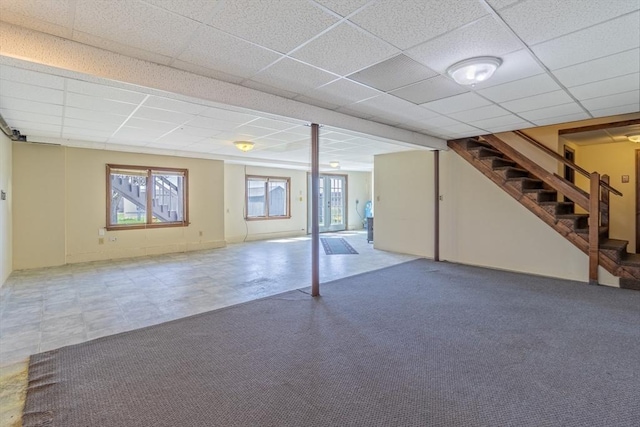 below grade area with stairway and a drop ceiling
