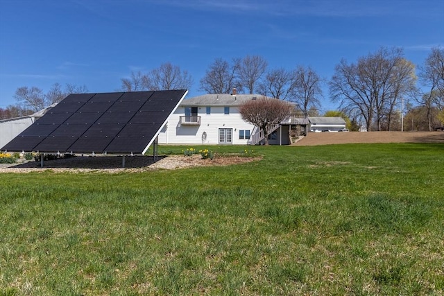 exterior space featuring a yard and solar panels