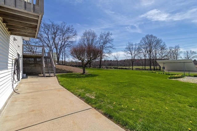 view of yard featuring a wooden deck and stairway