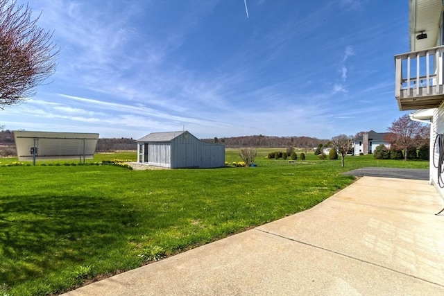 view of yard with an outbuilding and a storage shed