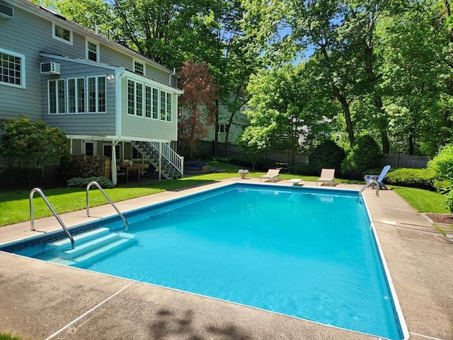 view of swimming pool featuring stairs, a yard, a fenced in pool, and a fenced backyard