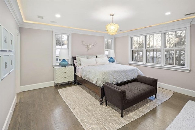 bedroom featuring crown molding, wood finished floors, and baseboards