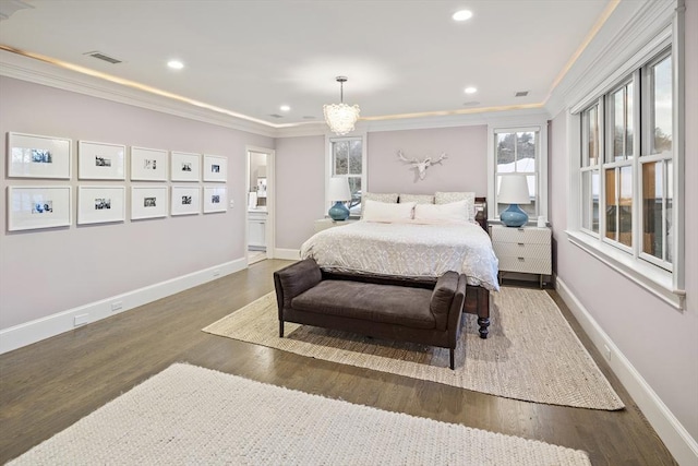 bedroom with visible vents, wood finished floors, and ornamental molding