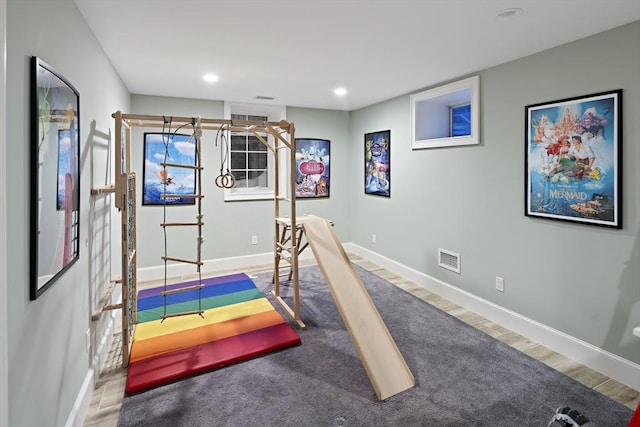 workout room with recessed lighting, wood finished floors, visible vents, and baseboards