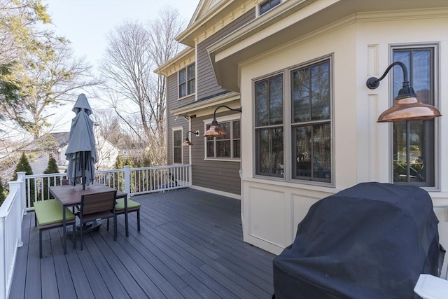 deck featuring outdoor dining space and area for grilling