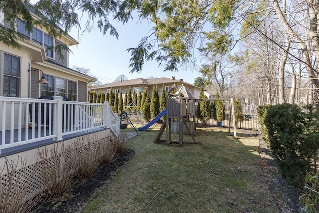 view of yard featuring fence and a playground