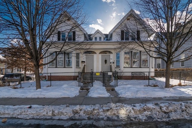 view of front of home with a fenced front yard and a gate