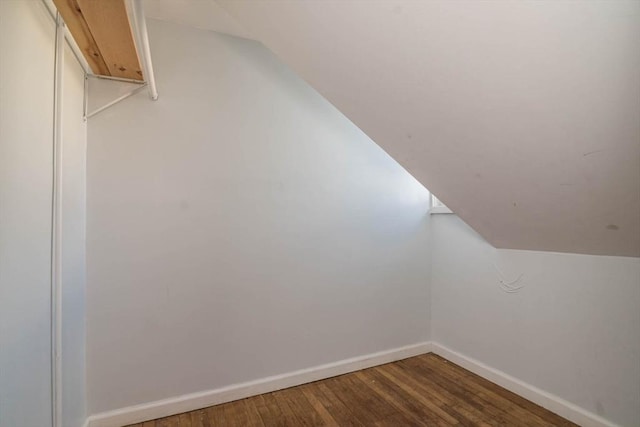 bonus room featuring lofted ceiling, baseboards, and wood finished floors