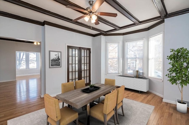 dining room featuring a wealth of natural light, french doors, light wood-type flooring, and ornamental molding