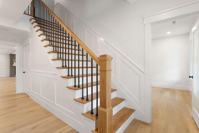 stairway with hardwood / wood-style flooring