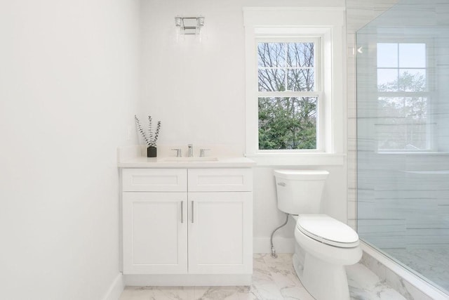 bathroom featuring vanity, toilet, and walk in shower