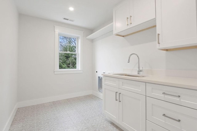 washroom with cabinets, hookup for a washing machine, sink, and electric dryer hookup