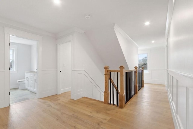 corridor featuring crown molding and light wood-type flooring